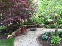 A Weeping Cherry is centered on this shaded patio