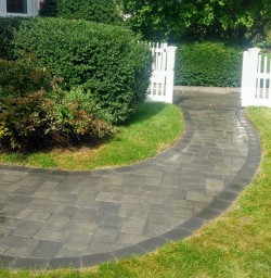 A new paver walkway connects front entry with driveway,