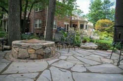 An irregular fieldstone patio and fire pit